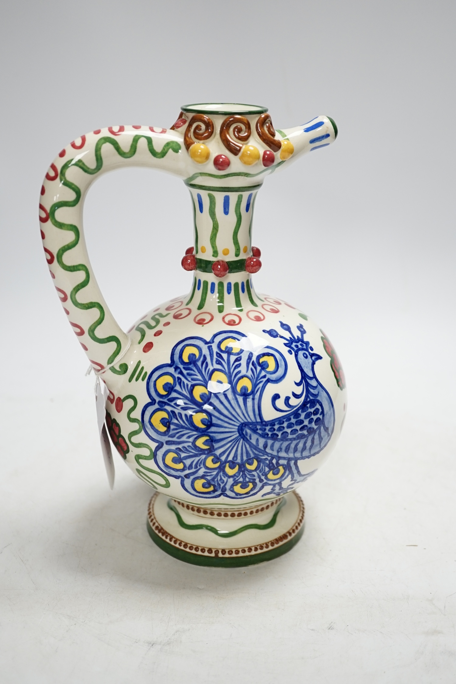 A Zsolnay jug or ewer decorated with peacocks and flowers, stamped ‘Zsolnay 830 and 07’ to the base, 24.5cm high